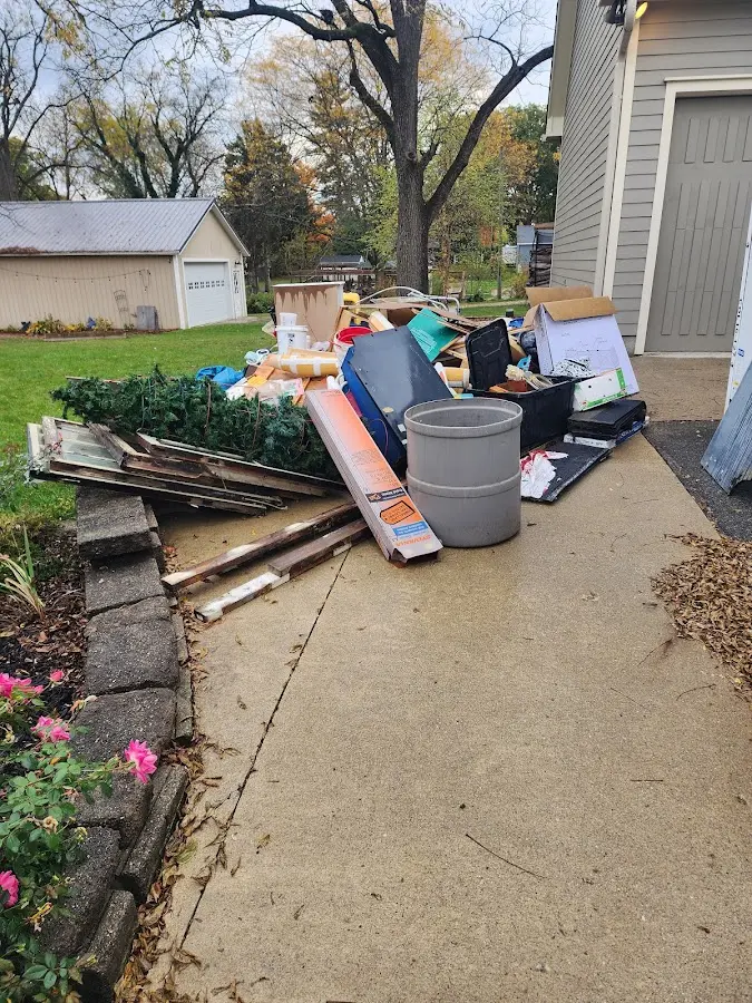 Dumpster being loaded with debris for 12 Yard Dumpster Rental in Charles Town